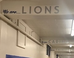 A picture of a hallway with the IB learner traits painted on the beams.