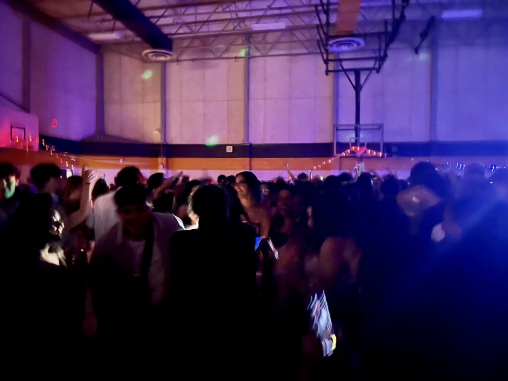 Students dance in the dark gym